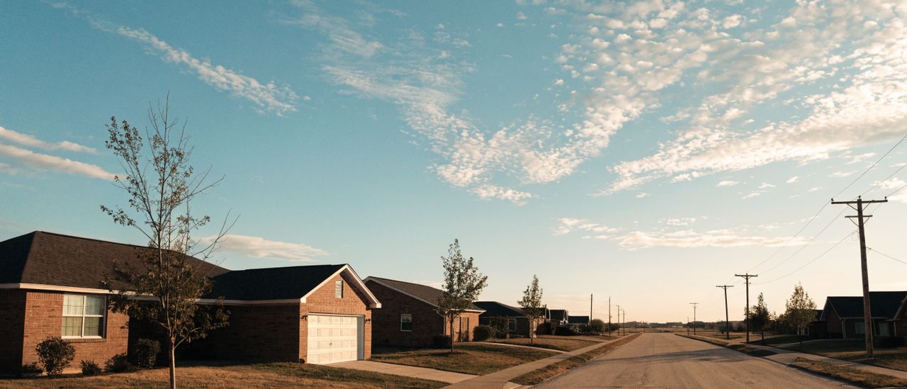 Street of single-story mid-century ranch homes with mature trees in Amarillo, Texas